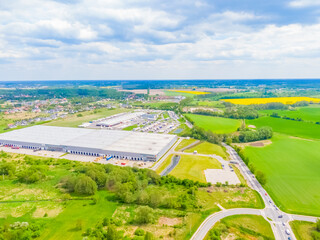 Aerial view of colorful trucks in the terminal waiting for unloading. Top view of the logistics center. Transportation. Freight transport, delivery. International road transport.