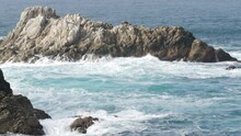 Rocky Craggy Dramatic Ocean Beach Near Big Sur, 17-mile Drive. Big Blue Waves Crashing On Cliff, Water Splashing, Sea Foam. Point Lobos, Monterey, California Coast, USA. Seamless Looped Cinemagraph.