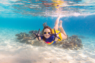 Wall Mural - Child snorkeling. Kids underwater. Beach and sea.