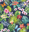 Tropical seamless pattern with palm leaves and exotic flowers. Floral summer design on a black background. Vector illustration.