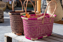 Colorfully Painted Wicker Baskets For Sale In A Store.