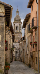 Sticker - narrow pedestrian street in the historic walled village of Antonana with colorful buildings