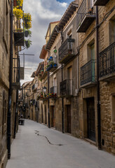 Sticker - narrow picturesque street with brown stone buildings in the historic city center of Laguardia in La Rioja