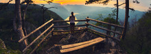 Young Woman On The Lookout Looking At Mountains And Valley During Summer Sunset