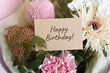 © Evgeniya Primavera - a beautiful bouquet of different fresh flowers and a gift card with an inscription happy birthday
