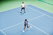Minimal High Angle Shot Of African American Couple Playing Tennis In Pair At Indoor Court, Copy Space