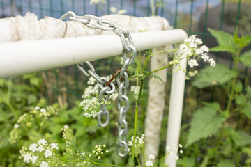 Wall Mural - Chain on pipe. Chain connects two pipes.