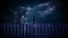 Raven Perched On A Cemetary Fence At Night