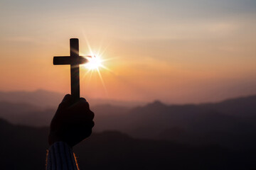 Wall Mural - silhouette hand holding cross