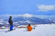 春スキーのニセコスキー場、羊蹄山を眺める滑走前のスノーボーダー達
