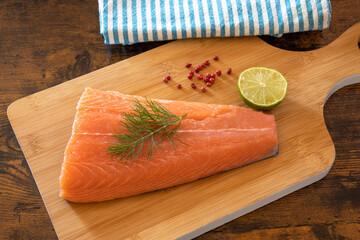 Wall Mural - top view of raw salmon fillet on wooden board