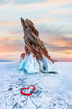 Beautiful Landscape Island Ogoy Winter Lake Baikal With Transparent Cracked Blue Ice Sunset Light. Concept Travel Russia