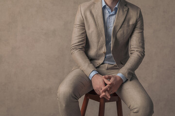 Wall Mural - businessman posing on chair with his body on the spotlight