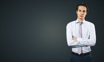 Poster - Business success concept with young smiling businessman folding his hands in white shirt and dark blue trousers on abstract black blank background with place for your logo or text. Mock up