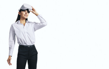 Aufkleber - Virtual reality concept with standing young woman looking up and VR headset on her head isolated on white background with place for your logo or text, mockup
