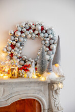 Christmas Decoration With Illuminated Lights On Marble Fireplace