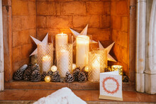 Christmas Candles And Greeting Card Inside Brick Fireplace