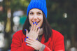 © Westend61 - Surprise young woman with blue nail polish covering mouth with hand