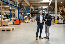 Colleagues Discussing In Meeting At Warehouse