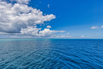 Wall Mural - Bright beautiful seascape, sandy beach, clouds reflected in the water, natural minimalistic background and texture, panoramic view banner. Sea ocean ecology nature concept. Blue sky clouds, idyllic