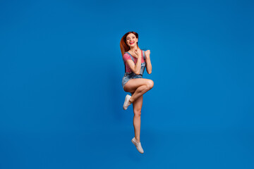 Wall Mural - Full size photo of overjoyed lady jumping raise fists celebrate luck isolated on blue color background