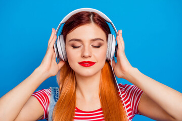 Canvas Print - Photo of sweet adorable young lady dressed denim clothes enjoying songs earphones isolated blue color background