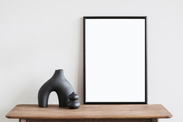 Wall Mural - Vertical poster art mockup with black frame and trendy vase on empty wall background, Template for artwork, painting or photo 