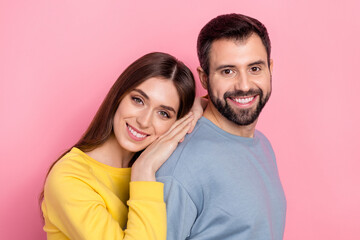 Poster - Portrait of attractive cheerful couple bonding spending day time isolated over pink pastel color background