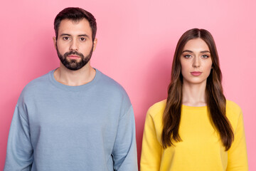 Wall Mural - Photo of two calm concentrated people look camera wear sweater isolated on pink color background
