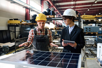 Poster - Young female engineer keeping hands over solar panel during presentation of new product to manager with tablet at meeting