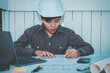 © Akira Kaelyn - Concept architects Asian woman engineer holding pen pointing equipment architects On the desk with a blueprint  calculator and laptop device in the home office, Selective Focus