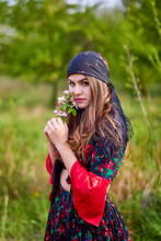 Beautiful Woman In Traditional Gypsy Dress Posing In Nature In Spring