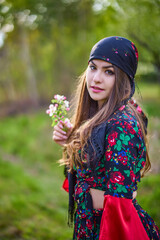 Wall Mural - beautiful woman in traditional gypsy dress posing in nature in spring