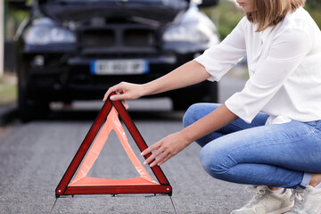 young woman setting the safety triangle