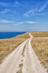 Wall Mural - Winding road next to a cliff on the Black Sea coast in Crimea.