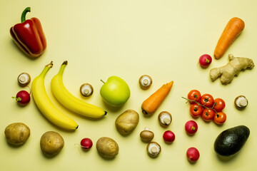 Wall Mural - Flat lay with ripe fruits and vegetables on yellow background.