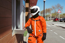 Anonymous Spaceman Standing Near Drive Thru Window
