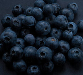 Wall Mural - Ripe sweet blueberries. Fresh blueberry background with space for text. Vegan and vegetarian concept. Macro texture of blueberries. Texture of blueberries close up