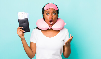 young adult black woman feeling extremely shocked and surprised. flight passenger concept