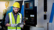 © atitaph - Male engineer safety helmet using a tablet to check Planning for the maintenance of metal machinery in industrial plants