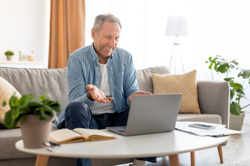 Poster - Mature man having video call using pc and talking