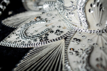 closeup photo of details of Mexican sombrero hat. Vintage Mexican on black. Velvet Mexican colorful Sombrero. Close-up photo. Soft focus