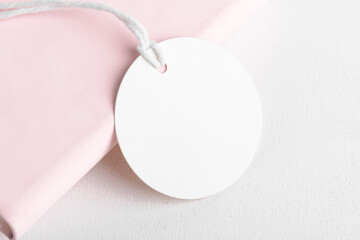 Wall Mural - Round white gift tag mockup on pink background. Blank paper circular price sticker tag mockup, Sale and Black Friday concept, element for design, label mockup