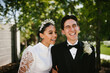 © Cavan Images - Multiracial groom and bride laughing after wedding ceremony