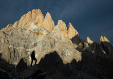 A Hiker Dwarfed Against The Massive Peaks Of The Fitzroy Massif,