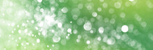Summer Green Sparkling Glitter Bokeh Background, Banner Texture. Abstract Defocused Lights Header. Wide Screen Wallpaper. Panoramic Web Banner With Copy Space For Design