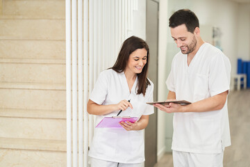 portrait of two physiotherapists looking at the following patient's record