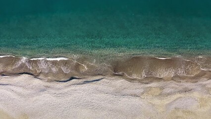 Wall Mural - Calm sea waves in the secluded beach in Summer