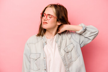 Wall Mural - Young caucasian woman isolated on pink background massaging elbow, suffering after a bad movement.