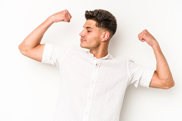 Young caucasian man isolated on white background showing strength gesture with arms, symbol of feminine power